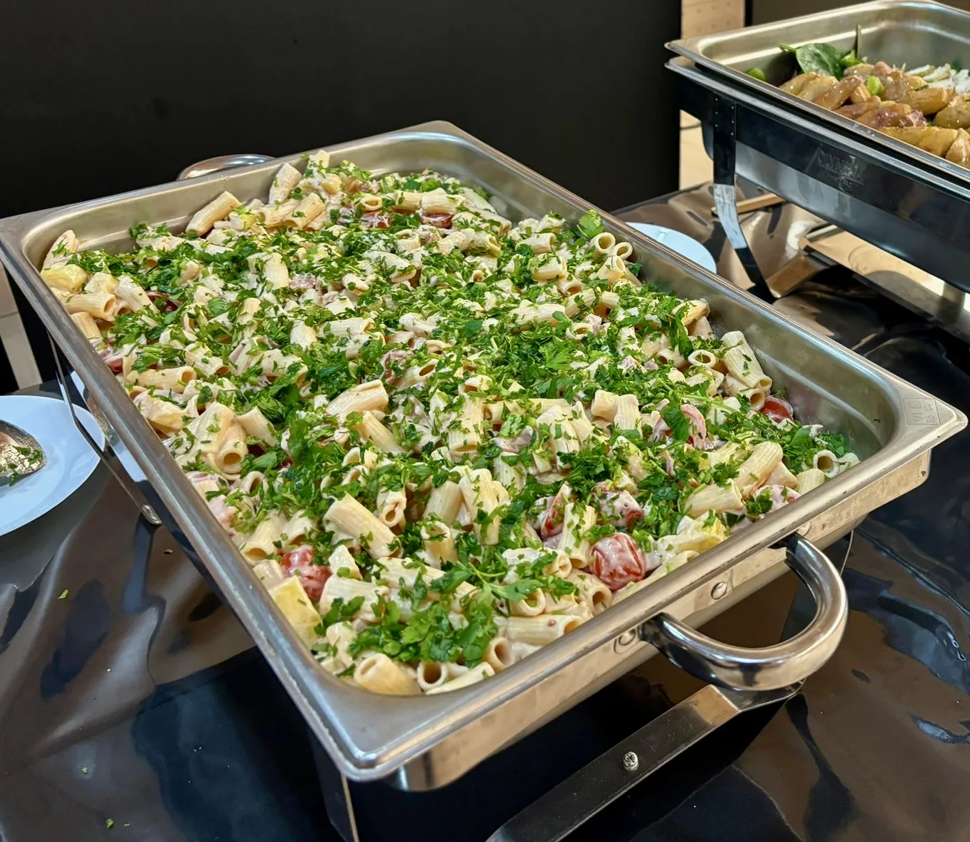 Organic pasta salad with herbs in a GN tray for daily collective catering menu