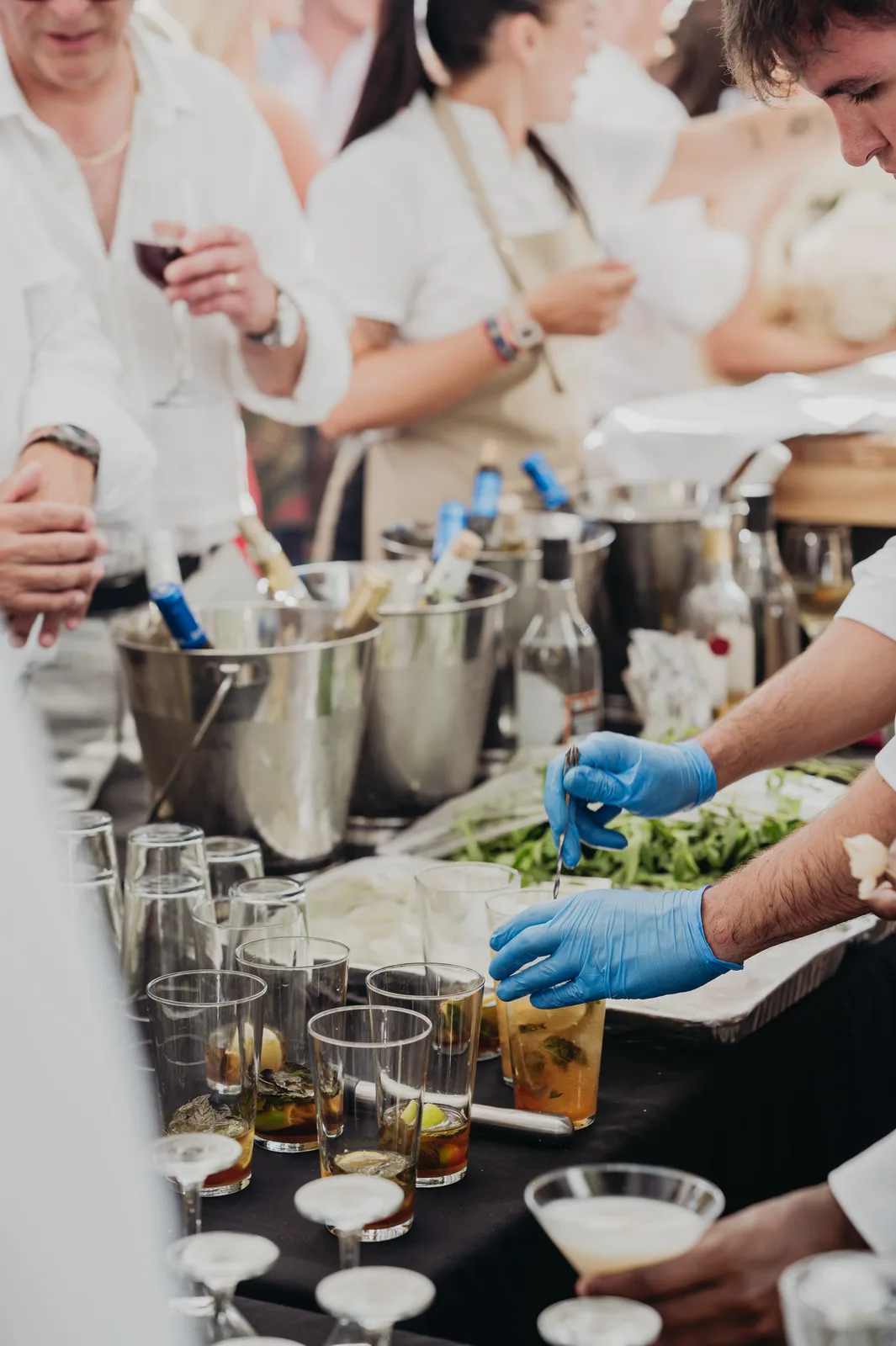 Full bar operation with SmartCatering team preparing mojitos and serving guests at outdoor Jewish wedding reception